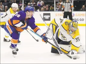  ?? Frank Franklin II / Associated Press ?? Nashville Predators goaltender Pekka Rinne (35) defends as the New York Islanders’ Anthony Beauvillie­r attempts to score during the second period on Tuesday.