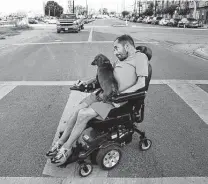  ?? Kin Man Hui / Staff file photo ?? Adam Boffa, a member of the city’s Disability Access Advisory Committee, checks street accessibil­ity in 2019. He died in 2020.