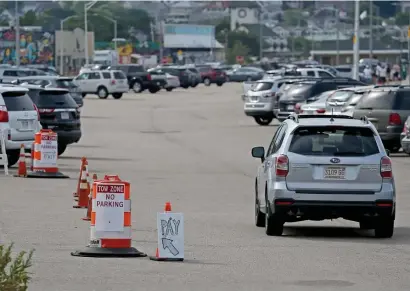  ?? STUART CAHILL / HERALD STAFF ?? MORE CONES BECAUSE OF COVID: The state Department of Conservati­on and Recreation is reducing parking capacity at Nantasket Beach State Reservatio­n to 50%, starting today.
