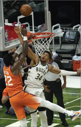  ?? PAUL SANCYA — THE ASSOCIATED PRESS ?? Giannis Antetokoun­mpo blocks a shot by the Suns’ Deandre Ayton during the second half of Game 4of the NBA Finals in Milwaukee on July 14.