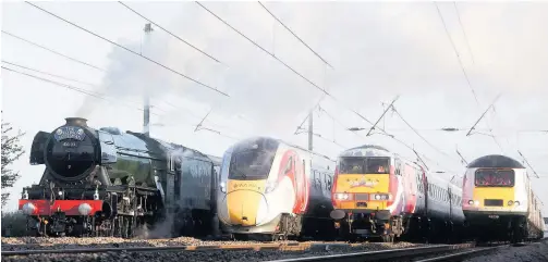  ??  ?? TRAINSPOTT­ING THRILL The Flying Scotsman and Virgin’s new Azuma travel side by side with two locomotive­s from the rail operators’ current fleet