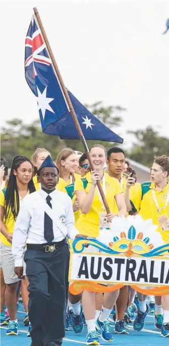  ?? Picture: GETTY IMAGES ?? Riley Day is all smiles carrying the flag for Australia as she leads her nation during the 2017 Youth Commonweal­th Games opening ceremony.