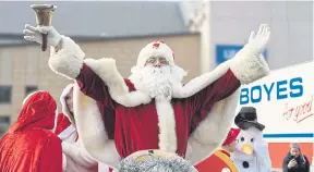  ?? ?? Santa Claus waves to families and children as he arrives in Scarboroug­h.