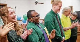  ?? Jay Janner / American-Statesman ?? Skye Petty, 12, from left, Malcolm Morgan-Petty and Brian Haynes-Morgan-Petty III, 16, celebrate during Skye and Brian’s adoption ceremony Nov. 9 at the Bastrop County Courthouse.