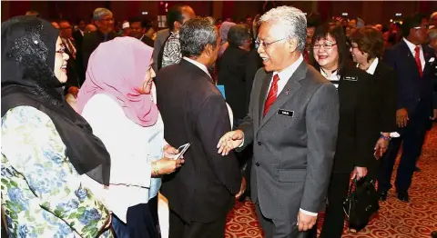  ??  ?? Idris and his deputy Datuk Dr Mary Yap greeting the ministry’s staff before delivering his new year message.