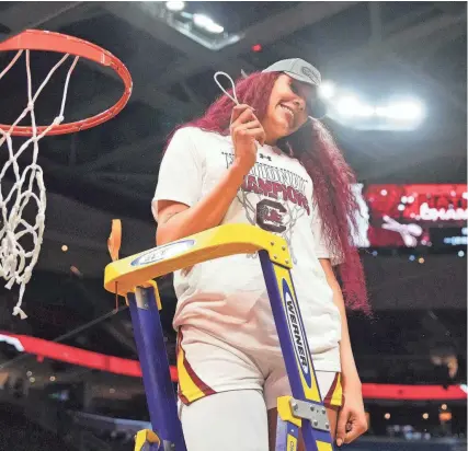  ?? KIRBY LEE/USA TODAY SPORTS ?? South Carolina center Kamilla Cardoso cuts down the net after the Gamecocks won the national championsh­ip on April 7 in Cleveland.