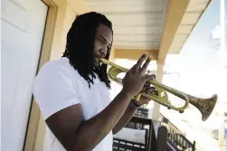  ?? CHERYL GERBER AP file ?? Musician Shamarr Allen, shown on his porch in New Orleans in 2009, is offering kids trumpets in exchange for guns. He says several musicians have offered free virtual lessons to kids who get the trumpets.