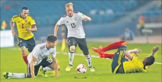  ?? AP ?? Germany's Dennis Jastrzembs­ki dribbles past Colombian players during their U17 World Cup match against Colombia in New Delhi on Monday. Germany won 40 and qualified for the quarterfin­als.