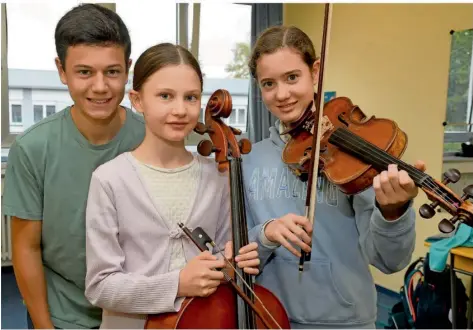  ?? FOTO: BECKERBRED­EL ?? Amélie (rechts), Aurelia und Elias Kalla in der Musikschul­e Püttlingen. Aurelia (12) spielt Violoncell­o, Amélie (14) Geige und Elias (15) Klavier.