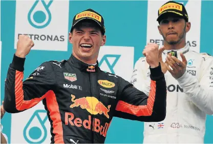  ?? /AFP ?? Risky move: Max Verstappen of Red Bull celebrates his win at the Malaysia Grand Prix with runnerup Lewis Hamilton.