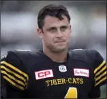  ?? CP PHOTO PETER POWER ?? Hamilton TigerCats quarterbac­k Zach Collaros (4) reacts while speaking with head coach June Jones, not shown, during warm-up before CFL football action against the Toronto Argonauts, in Hamilton, Ont., on September 4.