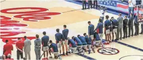  ??  ?? Six Mississipp­i men’s basketball players take a knee during the national anthem before a home game Saturday against Georgia in Oxford.