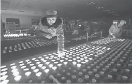  ?? CHINATOPIX VIA AP ?? A worker tests LED lights in February at a factory in Suining city in southweste­rn China’s Sichuan province.