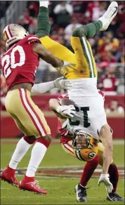  ?? TONY AVELAR — THE ASSOCIATED PRESS ?? Green Bay Packers wide receiver Allen Lazard (13) falls to the ground between San Francisco 49ers free safety Jimmie Ward (20) and Emmanuel Moseley during the first half of the NFL NFC Championsh­ip football game Sunday in Santa Clara