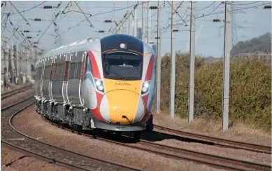  ?? DARREN WETHERALL. ?? Hitachi 800107 hustles south through Sandy, on the East Coast Main Line, with a test run on November 2. Hitachi has a 27.5-year government deal to maintain these trains, having built them. They will replace LNER’s HSTs built in the 1970s and Class 91s built in the 1980s. Meanwhile, a rolling stock conference in November heard a debate about the lifespan of trains.