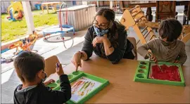  ?? VIRGINIA LOZANO/NEW YORK TIMES ?? Josefina Lopez paints with children last month at Ohana Family Child Care in Vista, California. The Biden administra­tion’s proposed American Families Plan would expand access to education and child care.