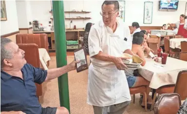  ??  ?? Harlan Lee, 63, owner, serves costumers at his Sing High Chop Suey Shop in downtown Phoenix.