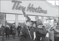  ?? CHRIS YOUNG, THE CANADIAN PRESS ?? Labour groups held rallies at Tim Hortons across Ontario to protest actions of some franchises following a raise in the minimum wage.