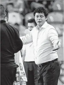  ??  ?? Dynamo coach Wilmer Cabrera questions officials after a goal by the Union on July 25. He is concerned about the number of matches his club has finished down a man because of ejections.