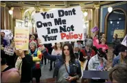  ?? ASSOCIATED PRESS FILE PHOTO ?? Marissa Messinger, of Lake View, Iowa, center, holds a sign during a rally to protest recent abortion bans, at the Statehouse in Des Moines, Iowa.