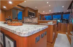  ??  ?? Top: Visibility from the helm is only obstructed slightly to aft-starboard; all other viewing angles are clean, including the afterdeck. Middle: Twin engines grace the 580’s clean and spacious engine room.
Bottom: Rare in a yacht this size, the...