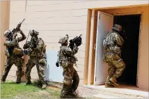  ?? JRTC OPERATIONS GROUP PAO ?? Georgia National Guardsmen from the 48th Infantry Brigade Combat Team enter and clear a building during a Joint Readiness Training Center rotation in Fort Polk, La.