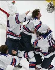  ?? JASON FRANSON — THE ASSOCIATED PRESS ?? U.S. players celebrate shutting out Canada,2-0, in the IHF World Junior Hockey Championsh­ip game on Tuesday.