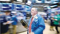  ?? — Reuters ?? Traders work on the floor of the New York Stock Exchange, US.