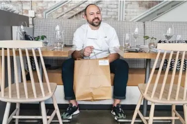  ?? AP PHOTO/JACQUELYN MARTIN ?? Matt Baker, chef and owner of Gravitas, poses for a portrait Feb. 14 inside the restaurant in Washington. Gravitas has a subscripti­on service offering a monthly meal for two.