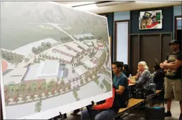  ?? Nikolas Samuels/The
Signal ?? An artist rendering of Castaic High School sits at the entrance of a meeting. Melanie Hagman, Hart High School’s assistant principal, was selected to become the founding principal of Castaic High School on Wednesday. Hagman was selected after an...