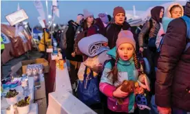  ?? Photograph: Wojtek Radwański/AFP/Getty Images ?? People queuing for a place on buses at the Medyka border crossing between Ukraine and Poland in March.