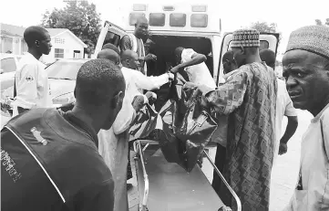  ??  ?? A victim being brought to the State Specialist Hospital in Maiduguri, northeaste­rn Nigeria the day after two suicide bombers struck a camp for displaced people in Dikwa. — AFP photo