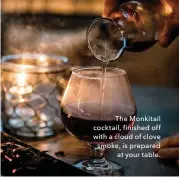  ??  ?? The Monkitail cocktail, finished off with a cloud of clove smoke, is prepared at your table.