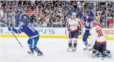  ?? COLE BURSTON THE CANADIAN PRESS ?? Maple Leafs forward Mitch Marner, left, and teammate Michael Bunting celebrate a goal by Morgan Rielly, not shown, as Washington Capitals goaltender Darcy Kuemper looks on in the second period in Toronto on Sunday. The Leafs won the game, 5-1.