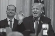  ?? OLIVIER DOULIERY/ABACA PRESS ?? U.S. President Donald Trump speaks as Labor Secretary Alexander Acosta looks on during a Hispanic Heritage Month celebratio­n at the East Room of the White House on Monday in Washington, D.C.