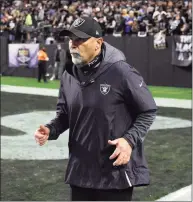  ?? Ethan Miller / Getty Images ?? Interim head coach Rich Bisaccia of the Las Vegas Raiders runs onto the field for a game against the Los Angeles Chargers on Sunday.