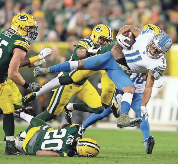  ?? DAN POWERS / WISCONSIN-USA TODAY NETWORKS ?? Detroit receiver Marvin Jones dives for a first down as he is tackled by Green Bay safety Josh Jones in the fourth quarter.