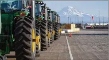  ?? TED S. WARREN/AP 2019 ?? John Deere tractors are readied for export to Asia last year in Tacoma, Washington. The U.S. trade deficit fell in September after hitting a 14-year high in August as exports outpaced imports.