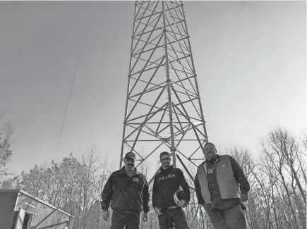  ?? RED CLIFF BAND OF LAKE SUPERIOR CHIPPEWA ?? Red Cliff Band of Lake Superior Chippewa officials stand in front of a communicat­ions tower that was installed on the reservatio­n last year. Equipment may be installed on the tower this year to expand wireless internet service on the reservatio­n.