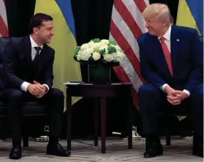  ?? SAUL LOEB/AFP/GETTY IMAGES ?? President Donald Trump and Ukrainian President Volodymyr Zelensky speak during a meeting in New York on September 25, 2019, on the sidelines of the United Nations General Assembly.