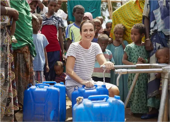  ??  ?? LEFT: Lorraine at one of the tap stands provided by Oxfam. These stands distribute 50,000 litres of water every day to those in need