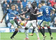  ??  ?? TUSSLE Tavernier and Goncalves of Hearts battle for ball and, below, Niko Kranjcar tries to create an opening