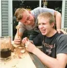  ?? COURTESY ?? Cody Mulligan sits near his father, Mike Mulligan. Cody was stabbed outside his home on Jan. 2, 2021.