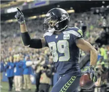  ?? ASSOCIATED PRESS ?? MAKING THEIR POINT: Doug Baldwin celebrates a touchdown during the Seahawks’ 27-24 victory against the Packers last night in Seattle.