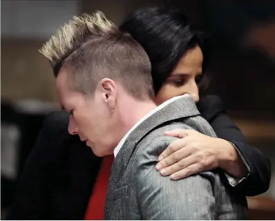  ?? Associated Press ?? ■ April Alley, front, daughter of Sedley Alley, hugs a member of her legal counsel in a Memphis, Tenn., courtroom. Alley was put to death by lethal injection in 2006 for the murder two decades earlier of Marine Lance Cpl. Suzanne Collins. Alley said his confession was coerced.