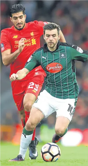  ??  ?? Liverpool’s Emre Can puts pressure on Plymouth’s Graham Carey.