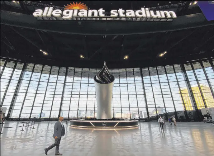  ?? L.E. Baskow Las Vegas Review-Journal @Left_Eye_Images ?? Raiders president Marc Badain looks to the 85-foot Al Davis Memorial Torch that will be lit for their opening game on Monday when the team hosts the New Orleans Saints.