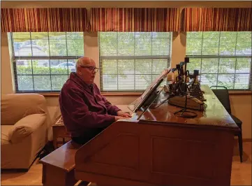  ?? JENNIE BLEVINS/ENTERPRISE-RECORD ?? Dick Emmons tickles the ivories on his pipe organ with “The Addams Family Theme” on Friday at his home on Autumnwood Drive in Chico.