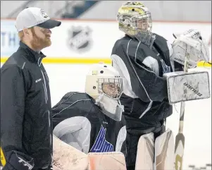  ?? JASON MALLOY/THE GUARDIAN ?? Goalie Dakota Lund-Cornish, centre, listens to instructio­ns during Monday’s Charlottet­own Islanders practice with teammate Matthew Welsh and goalie coach Paul Drew.