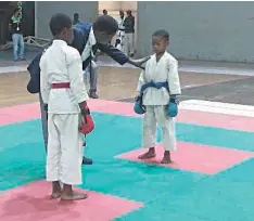  ?? ?? Two young boys set for action at the just concluded Shito- Ryu Karate championsh­ip held at National Stadium, Surulere, Lagos